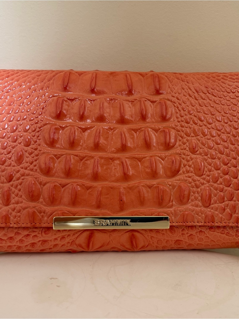 Brahmin flap front clutch wallet in a creamsicle shade crocodile